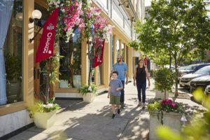 A family walks down Northampton Street in front of Meli restaurant